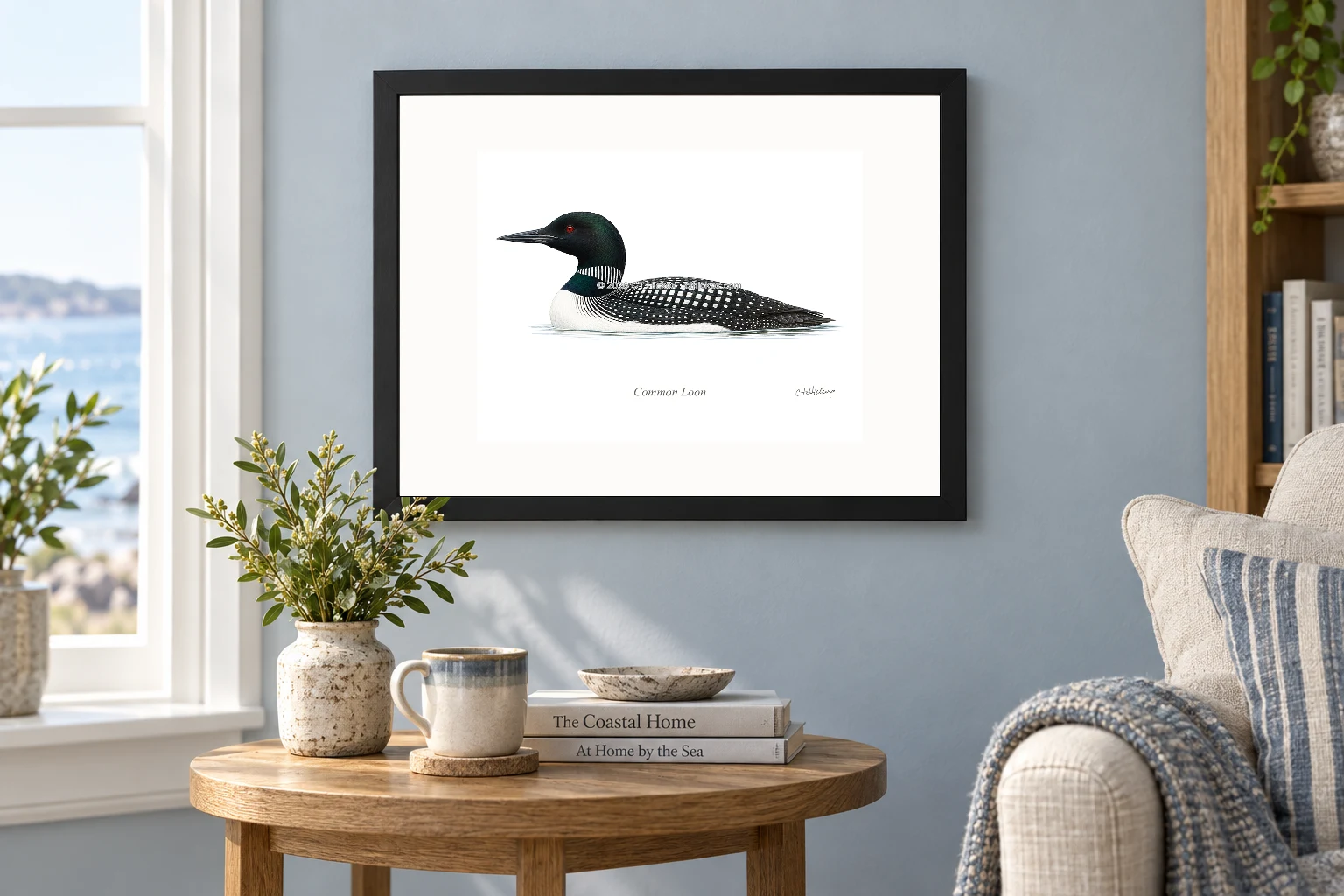 Common Loon in a black 14 × 11 landscape frame, white mat and 10 × 8 opening, above a wooden console